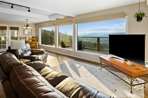a living room with a large window and a flat screen tv