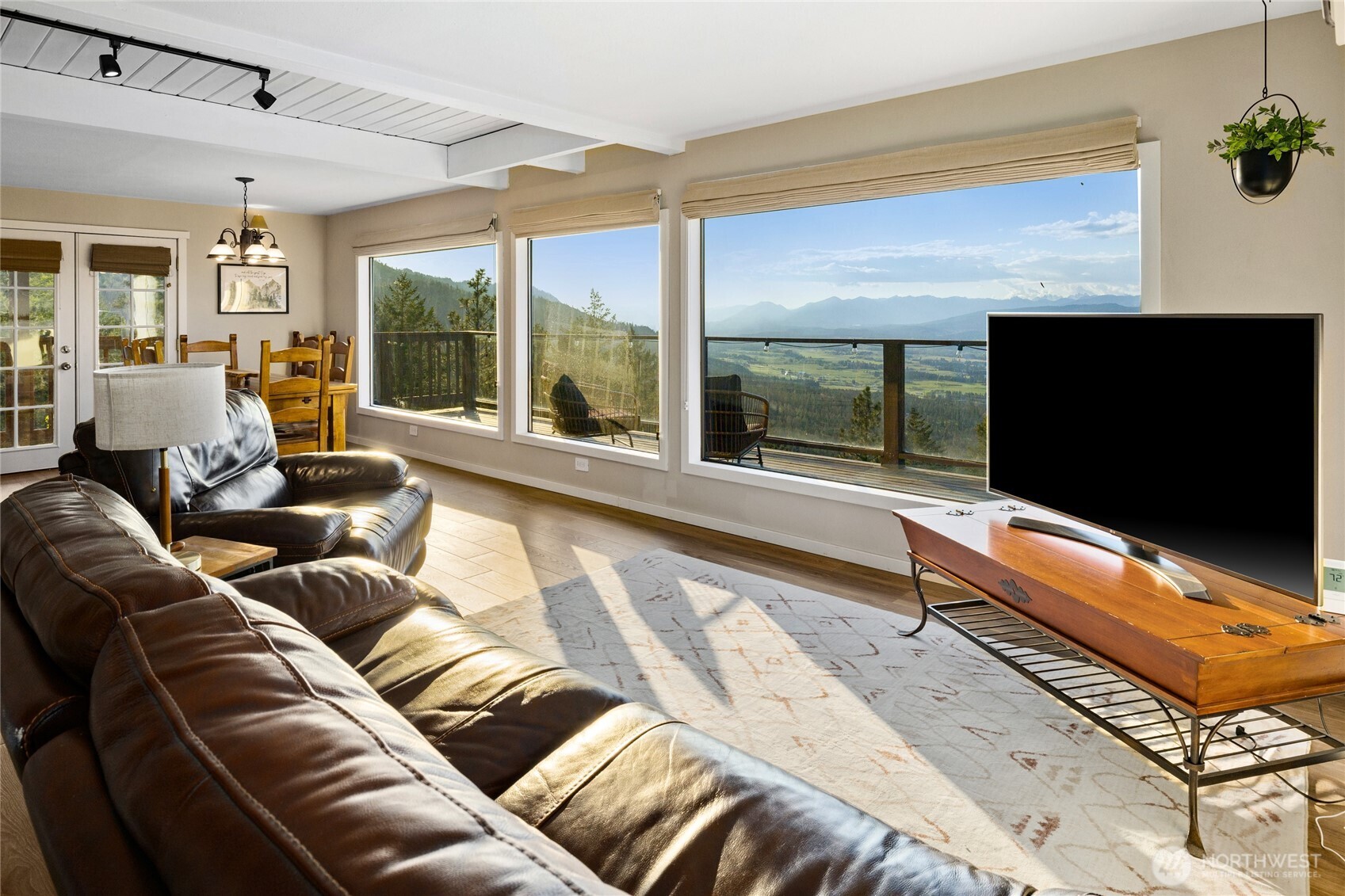 811 Horse Heaven Road Cle Elum, WA 98922 - Photo 4 of 40 a living room with a large window and a flat screen tv