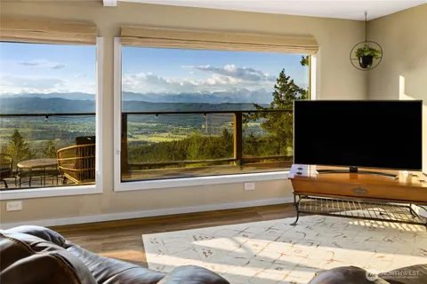 a living room with a large window and a flat screen tv