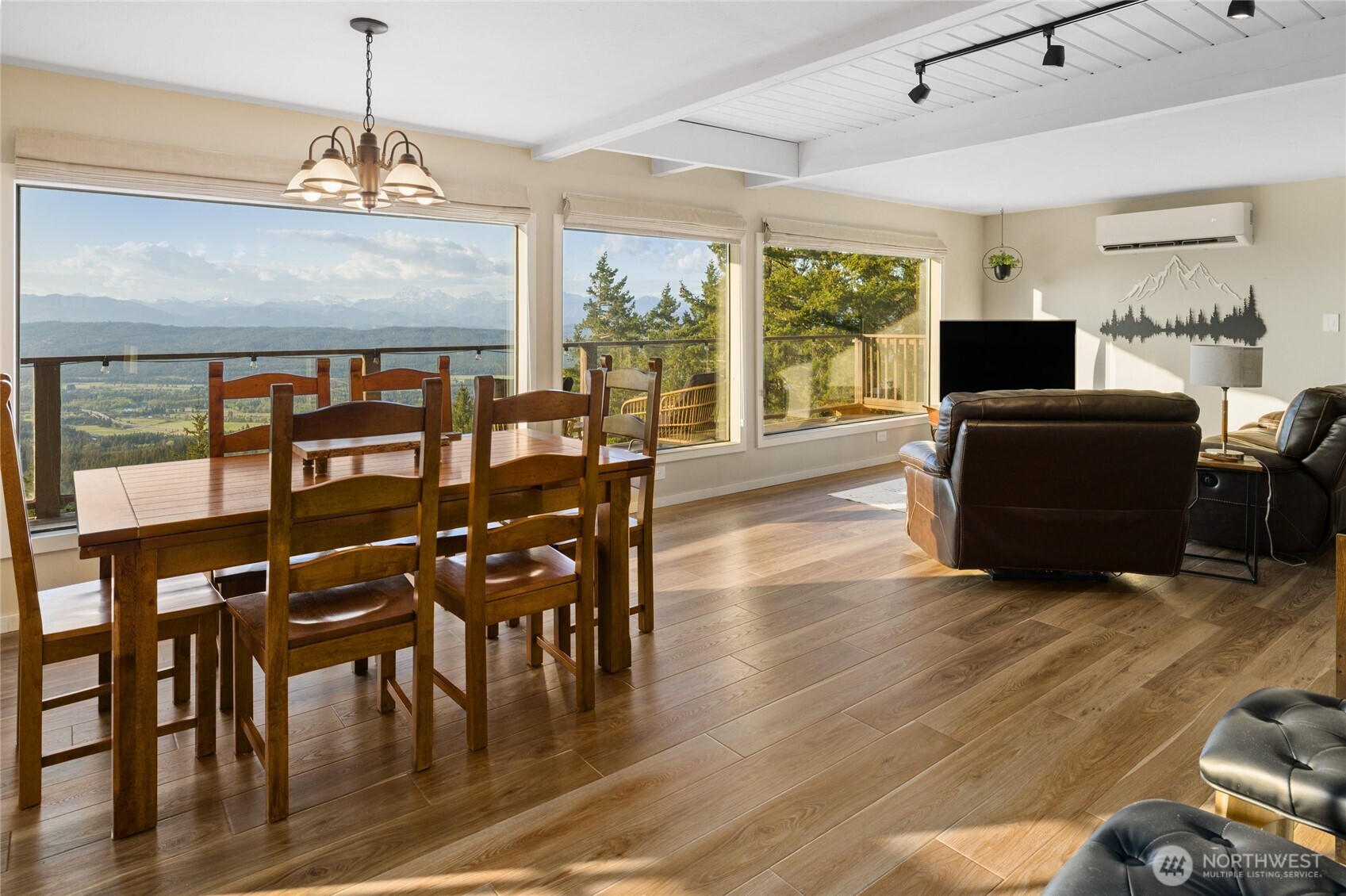 811 Horse Heaven Road Cle Elum, WA 98922 - Photo 8 of 40 a living room with furniture a dining table and a floor to ceiling window