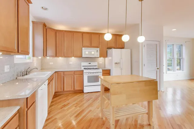 a large kitchen with cabinets and wooden floor