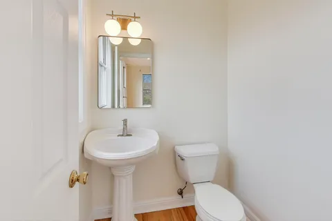 a balcony with couple of chairs and a table