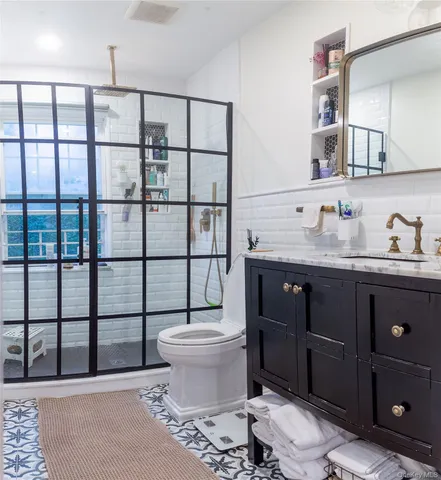 a bathroom with a sink toilet and mirror