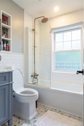 a bathroom with a toilet sink and shower