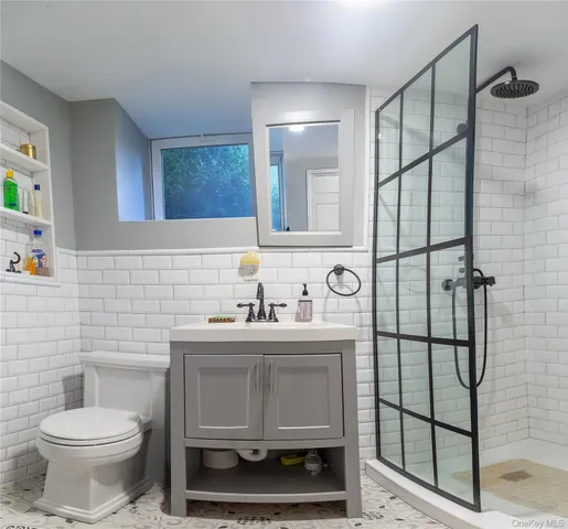 a bathroom with a toilet sink and mirror