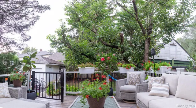 a view of a patio with couches table and chairs and potted plants