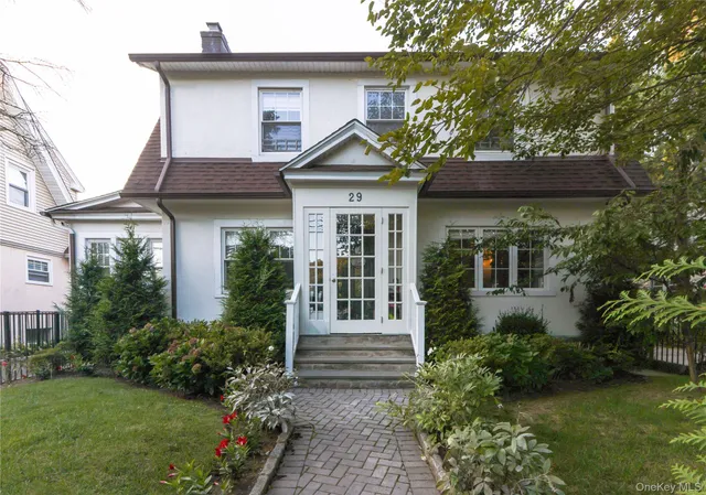 a front view of a house with garden