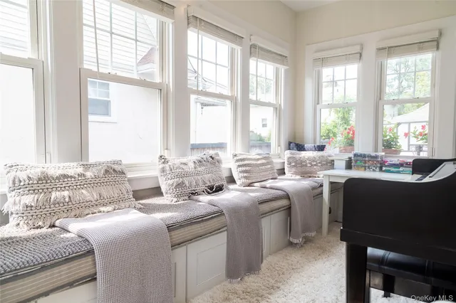 a living room with furniture and large windows