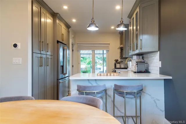 a kitchen with stainless steel appliances a sink stove and refrigerator