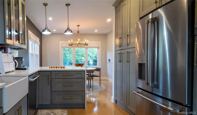 a kitchen with a refrigerator a sink and cabinets