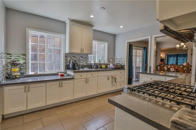 a kitchen with stainless steel appliances granite countertop a stove a refrigerator and a sink