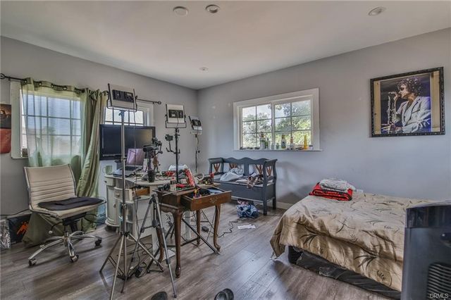 a bedroom with furniture and a wooden floor