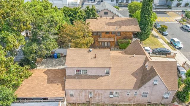 an aerial view of a house with a yard