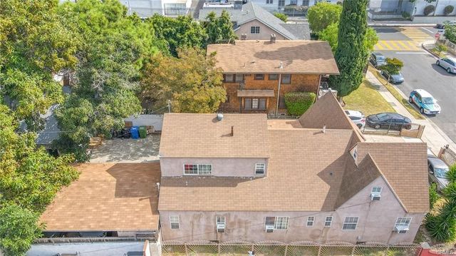 an aerial view of a house with yard