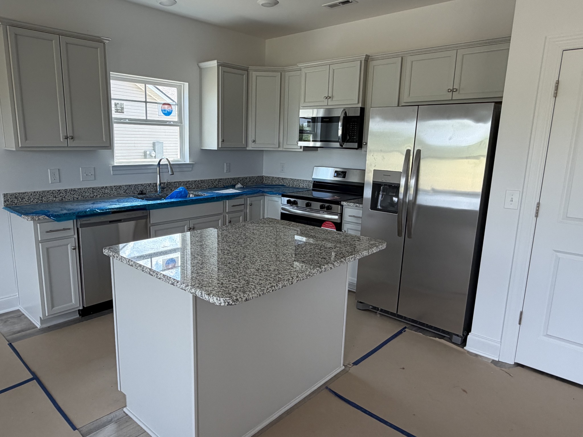 1209 Euclid Murfreesboro, TN 37127 - Photo 3 of 14 a kitchen with stainless steel appliances granite countertop a refrigerator a stove a sink and a microwave