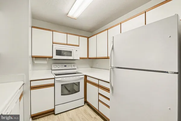 a kitchen with a sink and a refrigerator