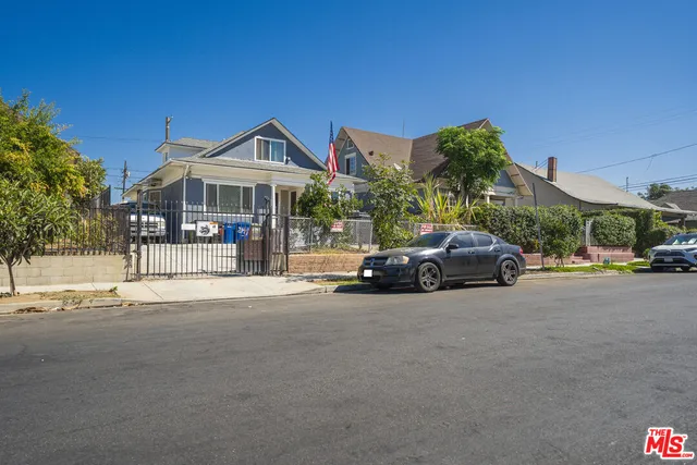a view of a cars park in front of a building