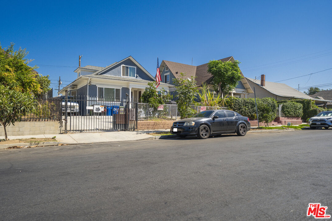 a view of a cars park in front of a building