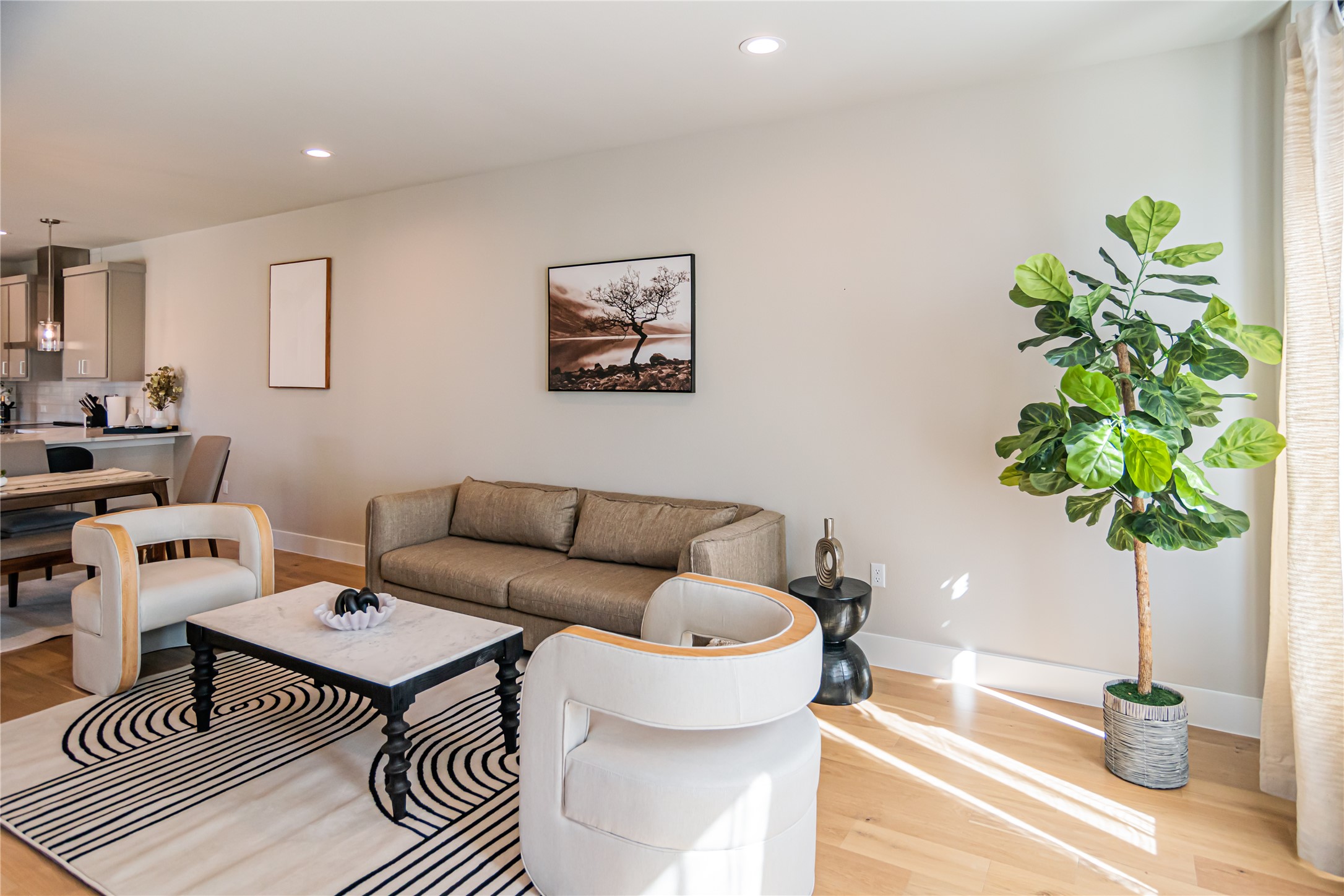 13309 Morris Road, Unit 11 Austin, TX 78729 - Photo 3 of 31 Recessed lighting illuminates this inviting living space, showcasing lustrous hardwood flooring and an open-concept design.