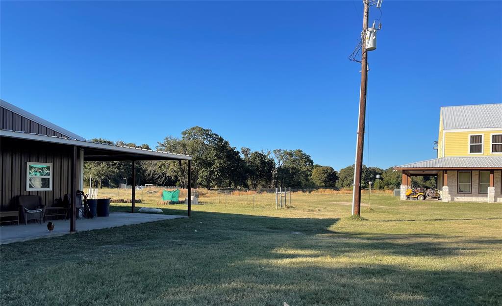1100 East Rabbit Cove Road Quinlan, TX 75474 - Photo 14 of 18 View of green lawn with a patio area distance to main house.