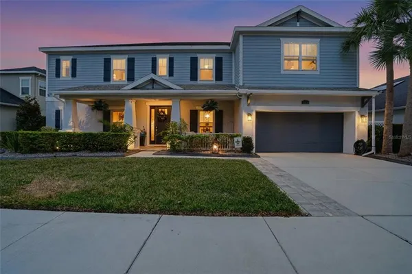 a front view of a house with a yard and garage