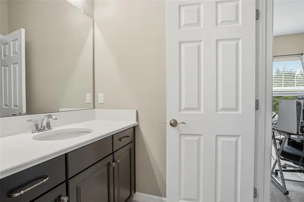 a view of a backyard with lawn chairs potted plants and a palm tree