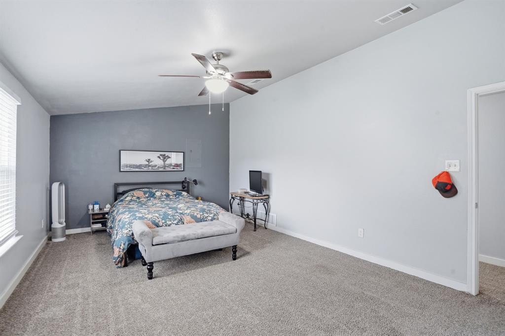 7701 John T White Road Fort Worth, TX 76120 - Photo 14 of 23 a bedroom with a bed and a chandelier