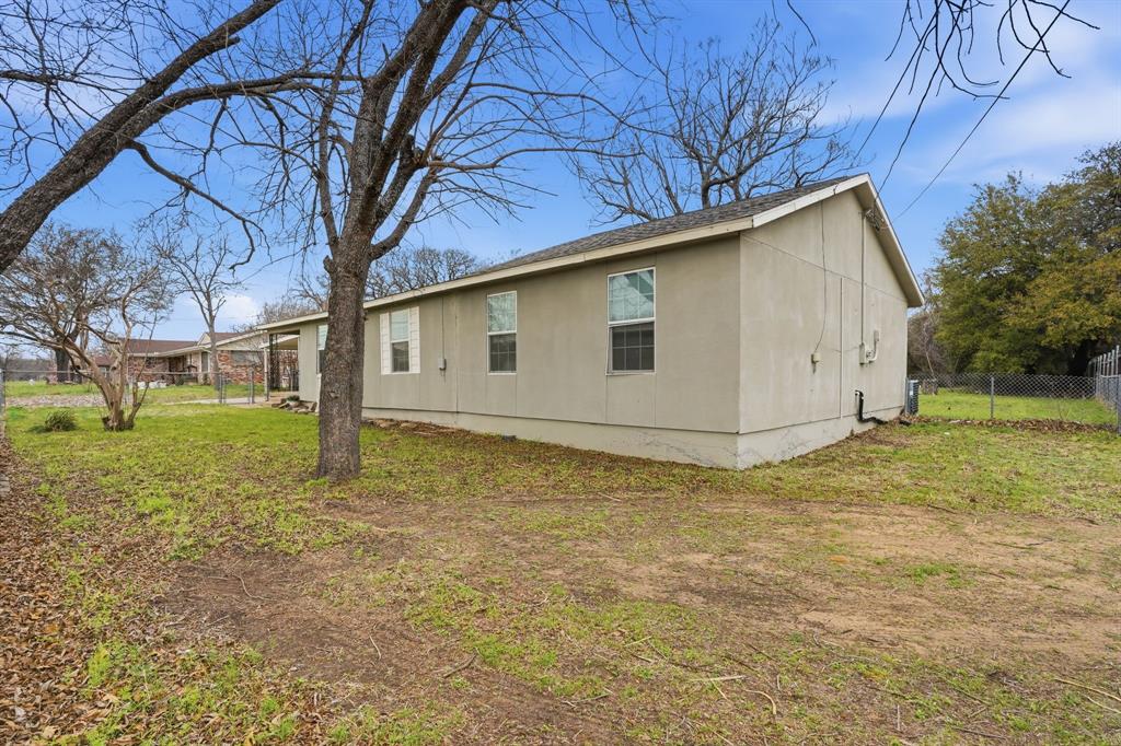 7701 John T White Road Fort Worth, TX 76120 - Photo 21 of 23 a backyard of a house with lots of green space