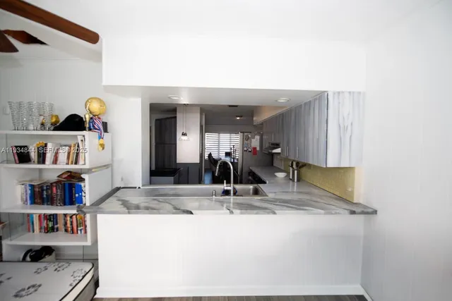 a view of living room with granite countertop furniture and a large mirror