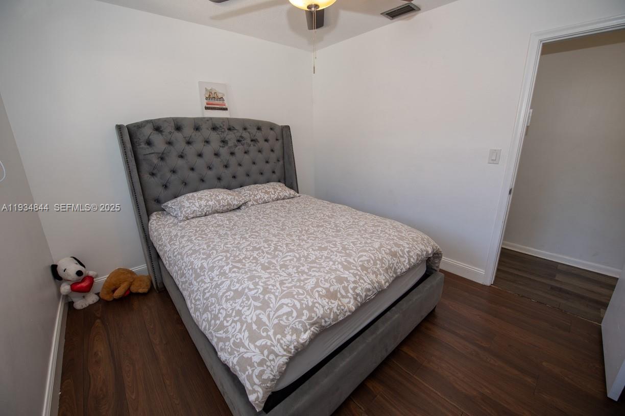 5012 Taft Street Hollywood, FL 33021 - Photo 16 of 36 a bedroom with a bed and window