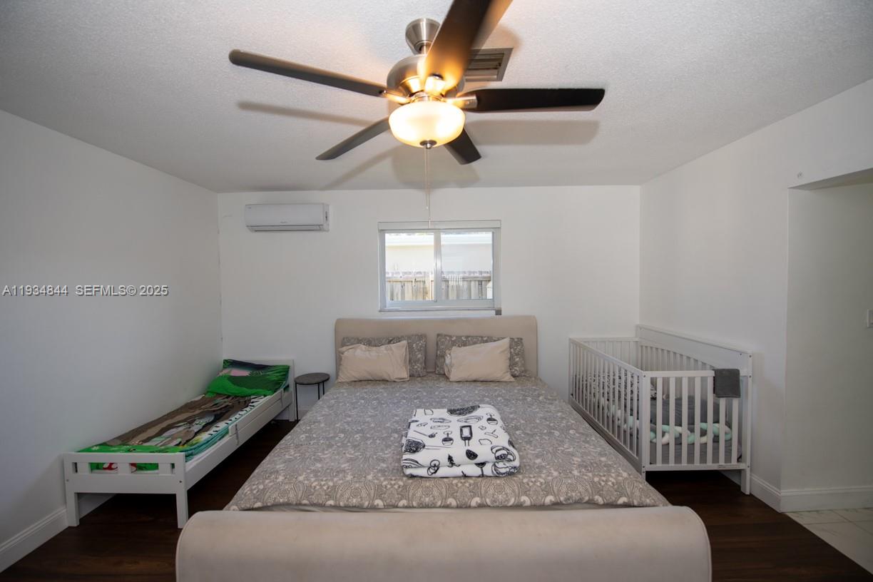5012 Taft Street Hollywood, FL 33021 - Photo 20 of 36 a bedroom with a bed and a window