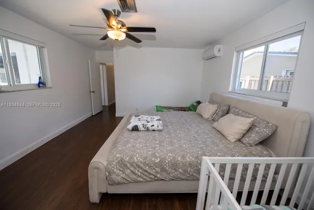 a bedroom with a bed and a chandelier fan