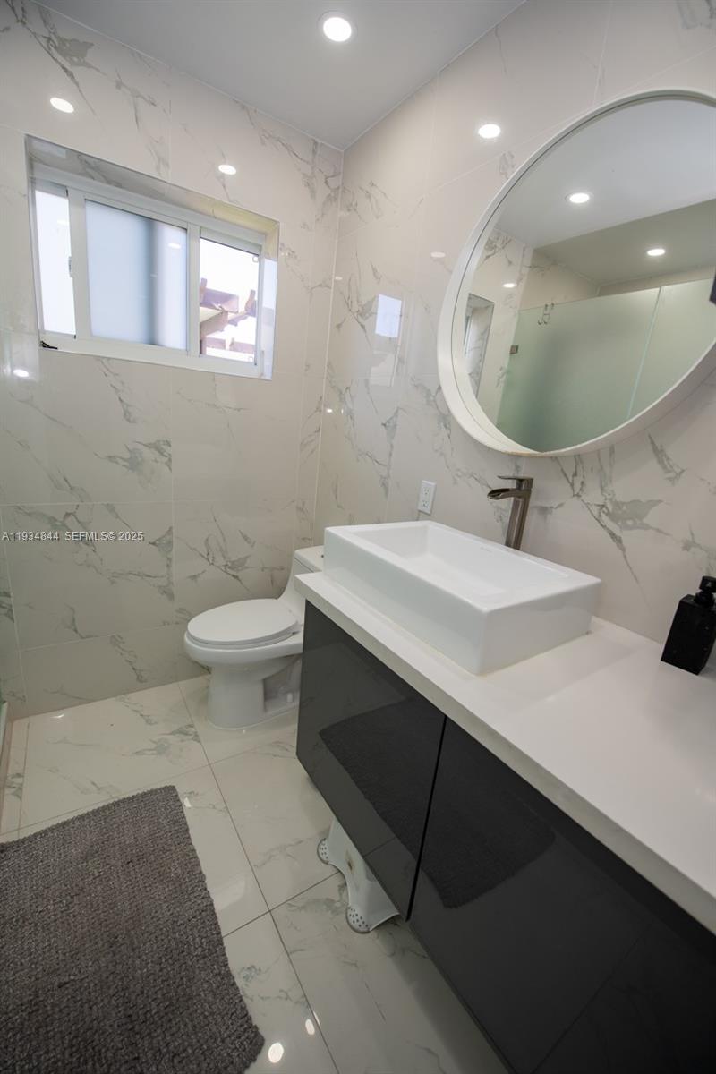 5012 Taft Street Hollywood, FL 33021 - Photo 22 of 36 a bathroom with a sink and a mirror