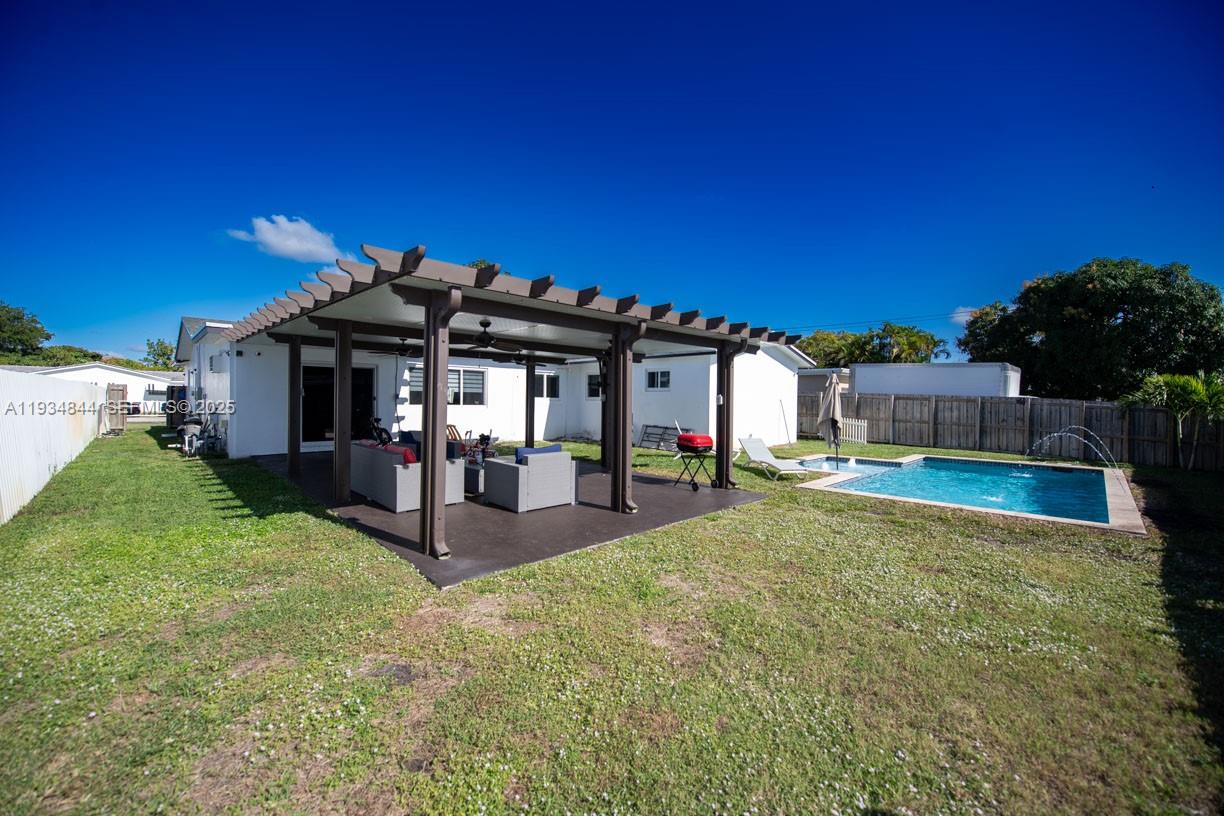 5012 Taft Street Hollywood, FL 33021 - Photo 29 of 36 a view of a house with backyard and porch