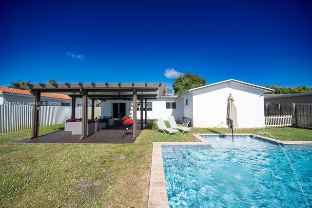 a view of swimming pool with a yard