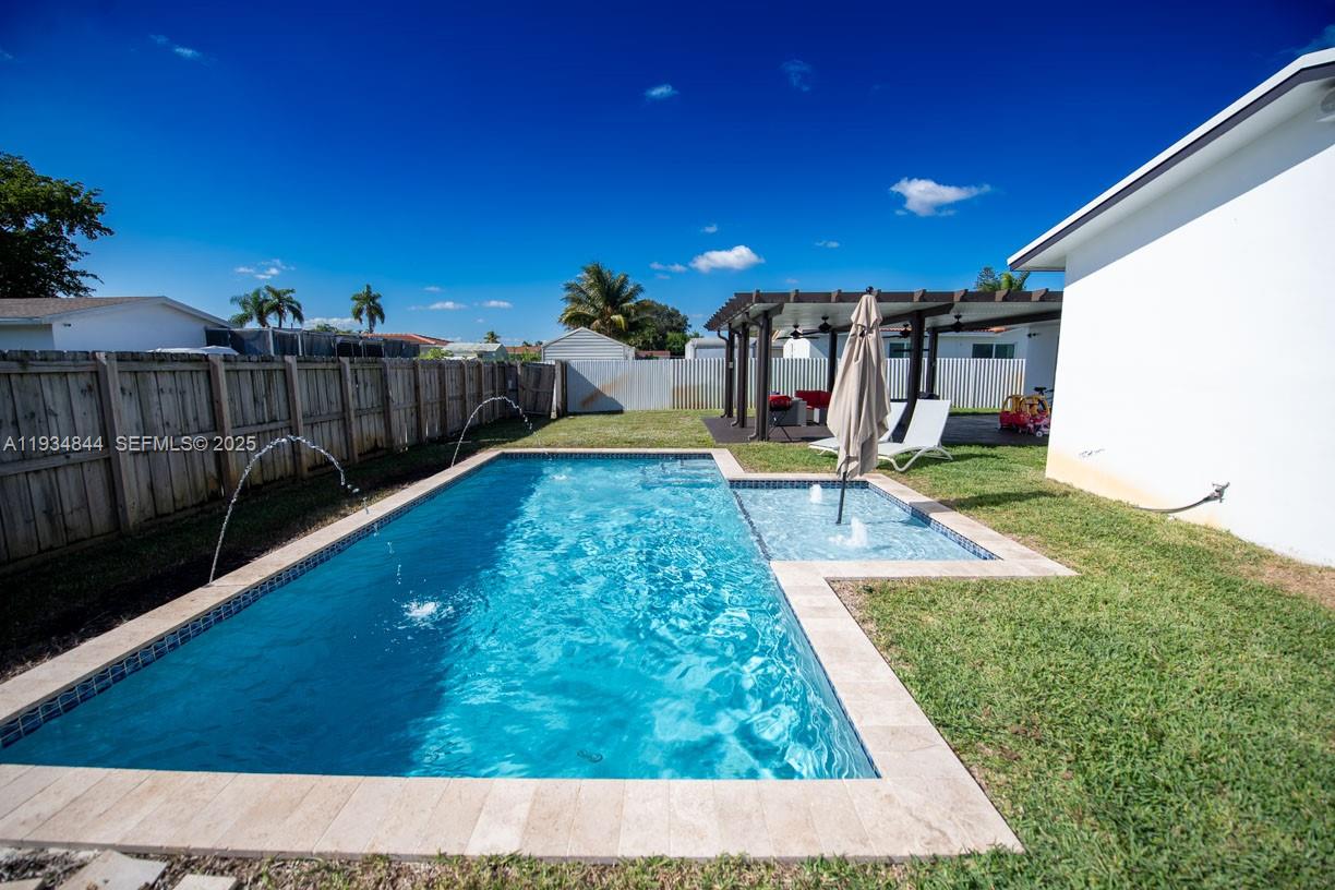 5012 Taft Street Hollywood, FL 33021 - Photo 32 of 36 a view of swimming pool with a yard