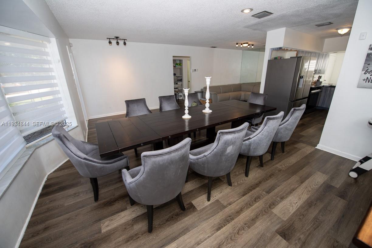 5012 Taft Street Hollywood, FL 33021 - Photo 5 of 36 a living room with couches chairs and a potted plant