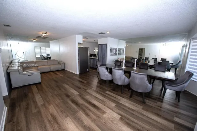 a living room with lots of furniture and kitchen view