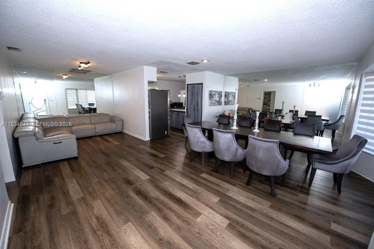 5012 Taft Street Hollywood, FL 33021 - Photo 6 of 36 a living room with lots of furniture and kitchen view