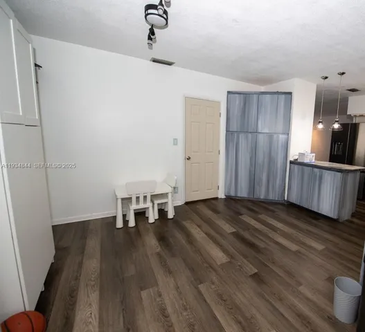 a view of a livingroom with furniture wooden floor and staircase