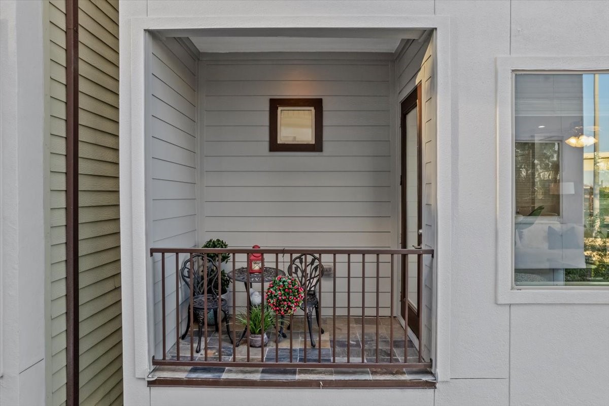 1005 Bingham Street, Unit 5 Houston, TX 77007 - Photo 16 of 50 This cozy patio features a small seating area currently set up with two chairs and a table, adorned with potted plants. It's an inviting space perfect for relaxation. Use your imagination.