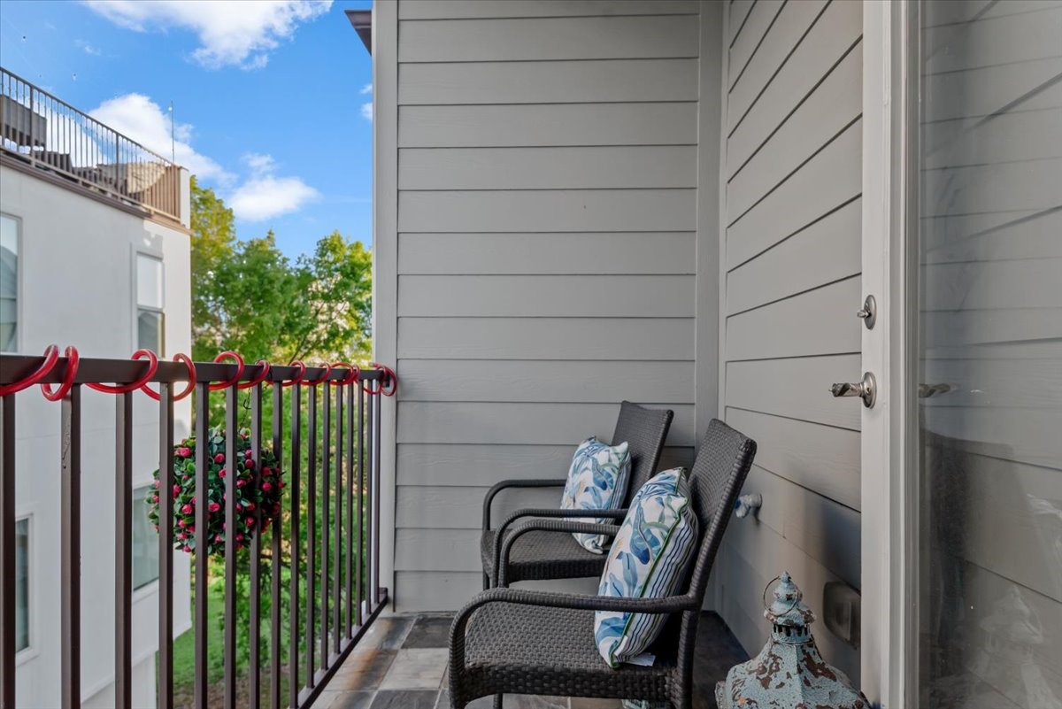 1005 Bingham Street, Unit 5 Houston, TX 77007 - Photo 39 of 50 This cozy balcony off the primary bedroom features a charming view of trees and neighboring buildings. Perfect for relaxing outdoors. It is off the primary bedroom.