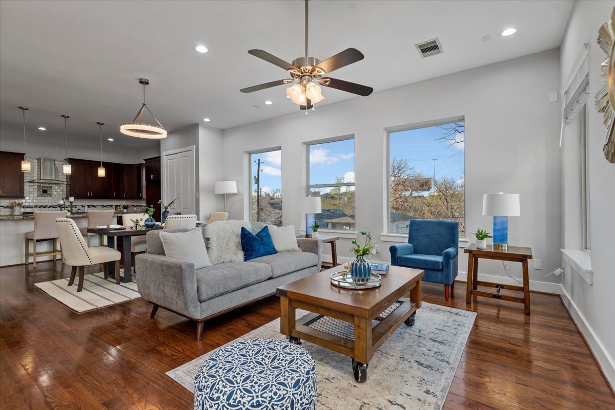 1005 Bingham Street, Unit 5 Houston, TX 77007 - Photo 10 of 50 This open-concept living area features a modern design with hardwood floors, large windows for natural light, and a cozy seating arrangement. The space seamlessly connects to a stylish kitchen and contemporary lighting, creating a perfect setting for entertaining or family gatherings.