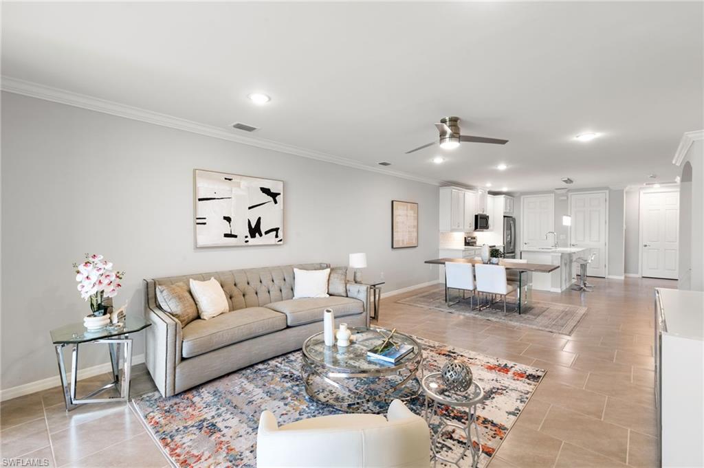 14618 Edgewater Circle Naples, FL 34114 - Photo 14 of 47 a living room with furniture and wooden floor