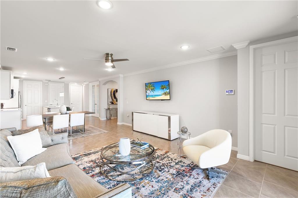 14618 Edgewater Circle Naples, FL 34114 - Photo 15 of 47 a living room with furniture and a table