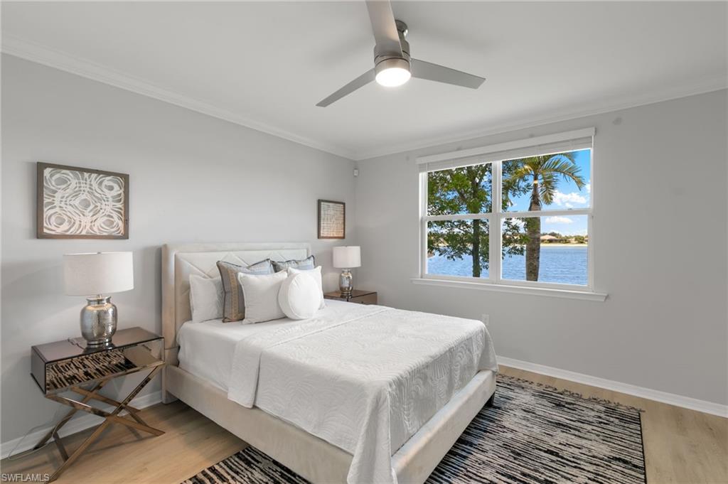14618 Edgewater Circle Naples, FL 34114 - Photo 16 of 47 a bedroom with a bed couches and window