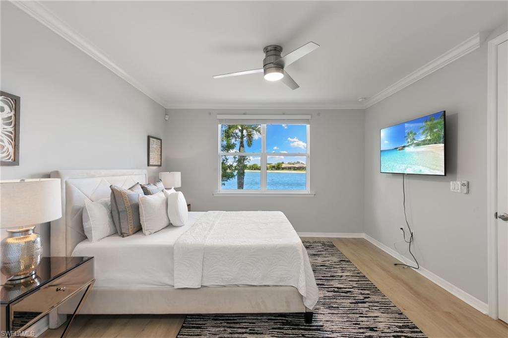 14618 Edgewater Circle Naples, FL 34114 - Photo 17 of 47 a bedroom with a large bed and a window