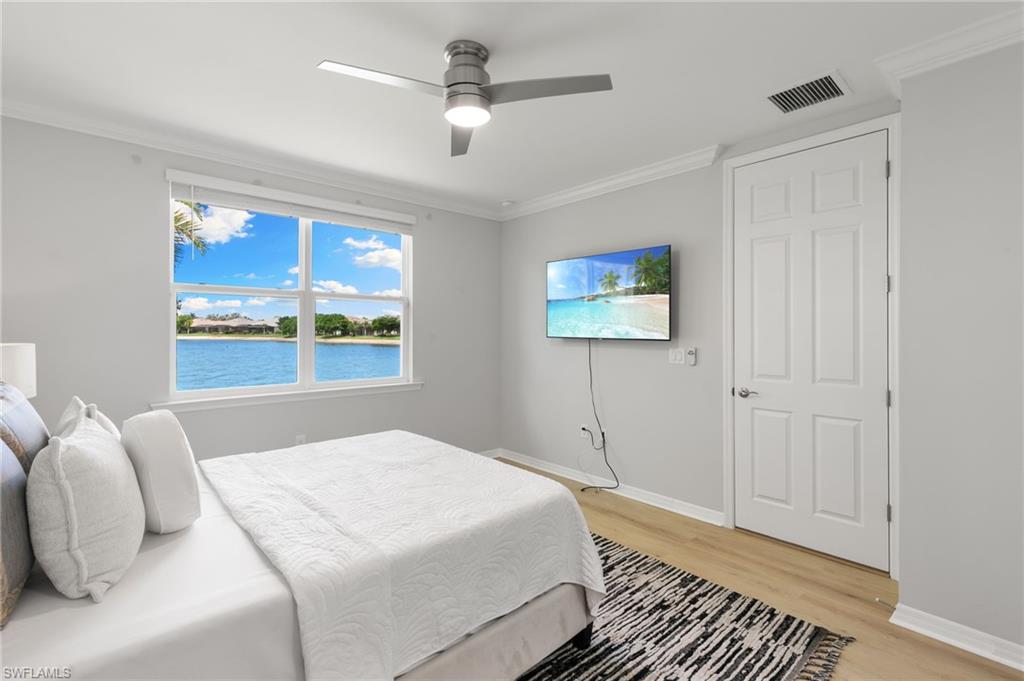 14618 Edgewater Circle Naples, FL 34114 - Photo 18 of 47 a bedroom with a bed ceiling fan and a window