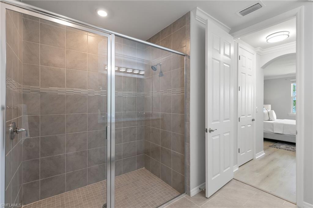 14618 Edgewater Circle Naples, FL 34114 - Photo 21 of 47 a bathroom with a shower and a sink
