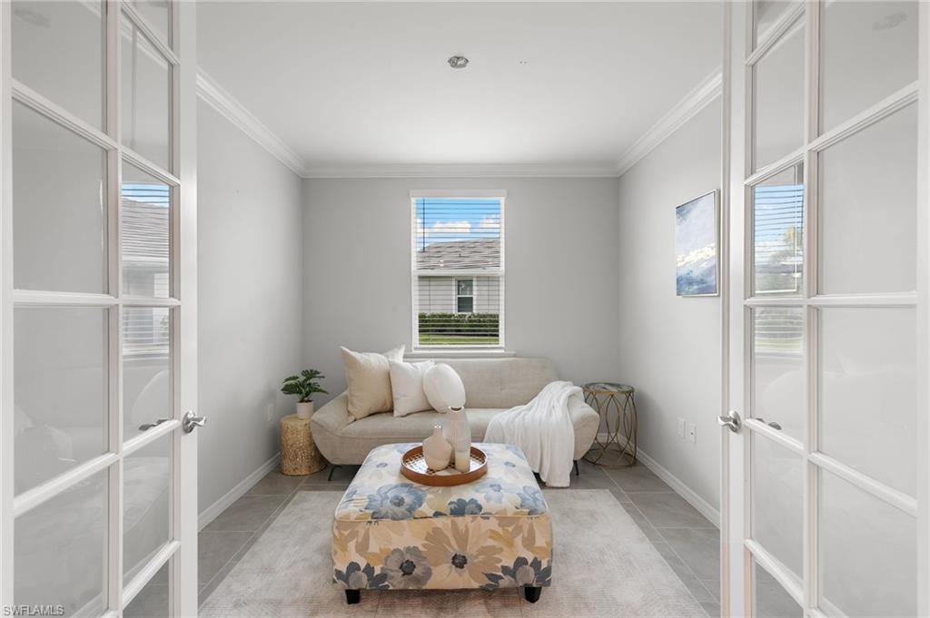 14618 Edgewater Circle Naples, FL 34114 - Photo 22 of 47 a bedroom with furniture and a window